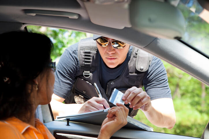 Officer signing driver a ticket