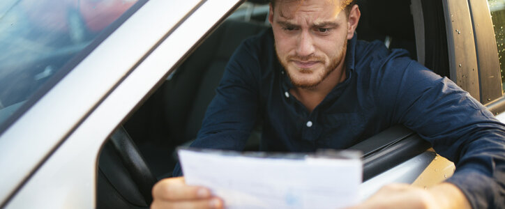 Young man receiving a traffic ticket