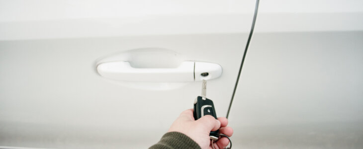 A man holding car keys in his hand.