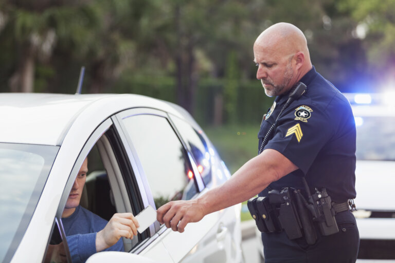 Police officer takes driver’s license during traffic stop